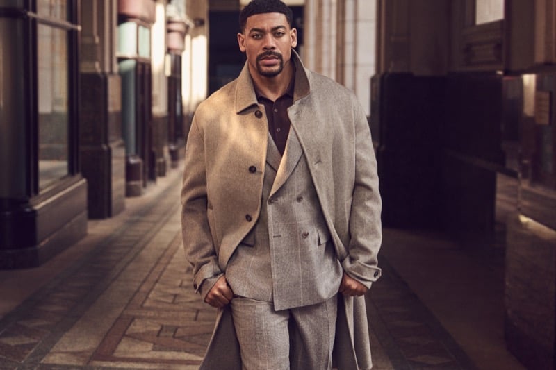 Aaron Pierre wears a gray coat over a plaid double-breasted suit for BOSS' fall-winter 2026 campaign