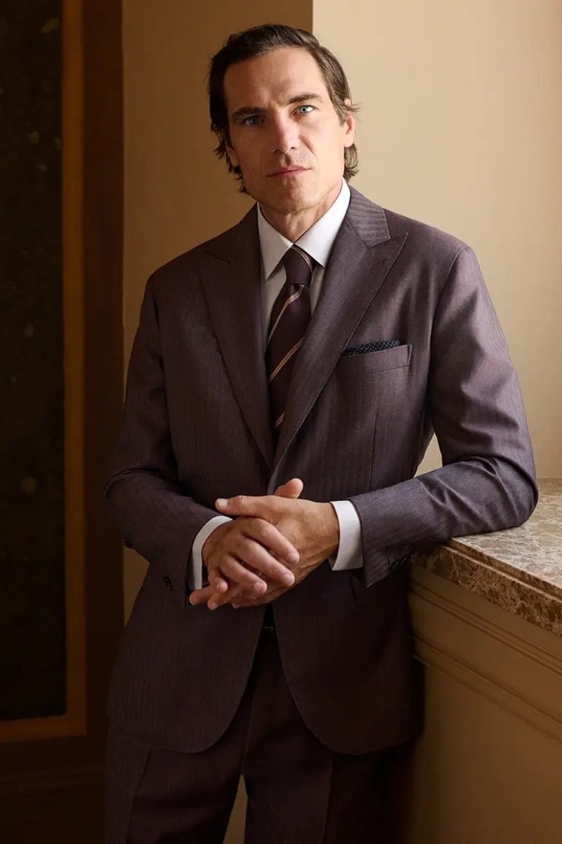Jerome Adamoli wears a pinstripe suit with a striped tie and patterned pocket square for Brioni's fall-winter 2026 campaign