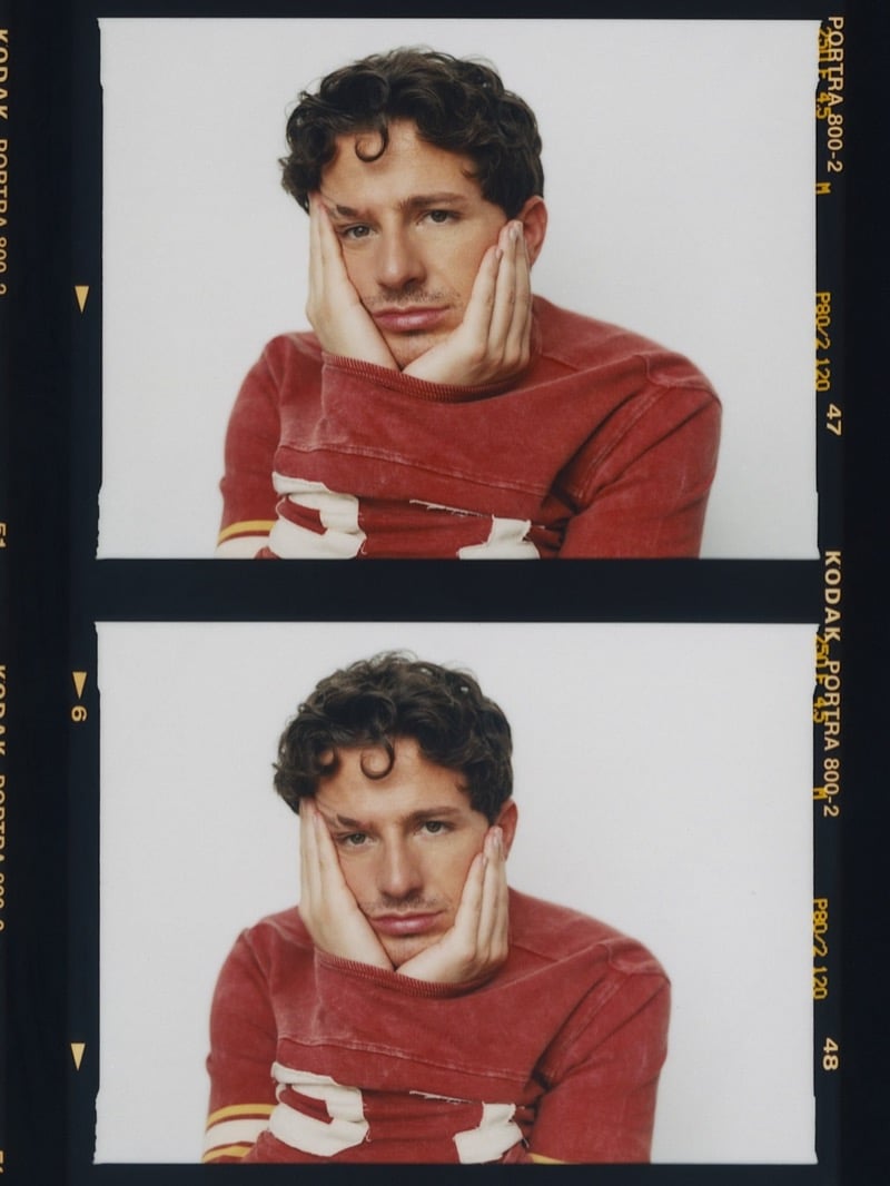 Contact sheet of Charlie Puth resting his face in his hands in a red jersey, two nearly identical frames