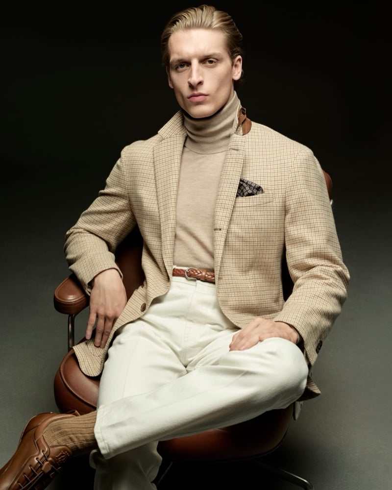 Colin Otto wears a beige check blazer with a tan turtleneck and cream trousers for Dunhill's fall-winter 2026 campaign