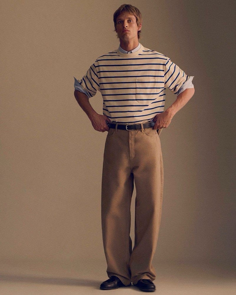 Yeray Allgayer wears a cream and blue striped tee with khaki wide-leg trousers and black loafers