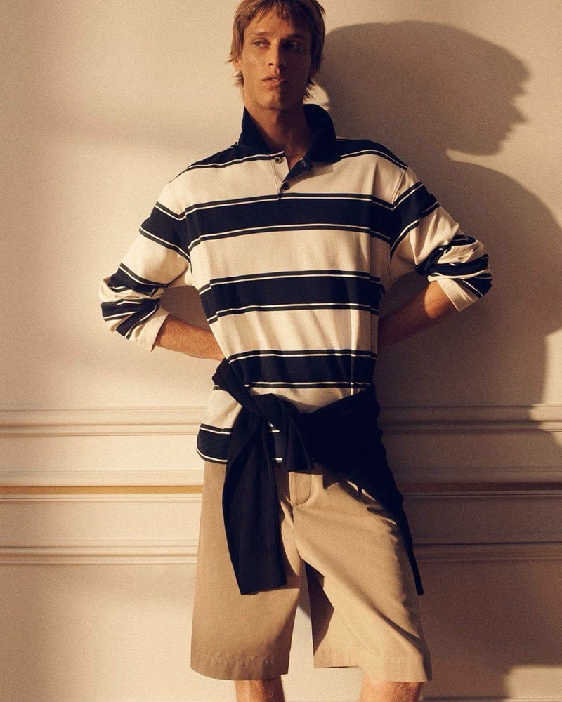 Yeray Allgayer wears a striped rugby polo with tailored shorts and a dark layer knotted at his waist