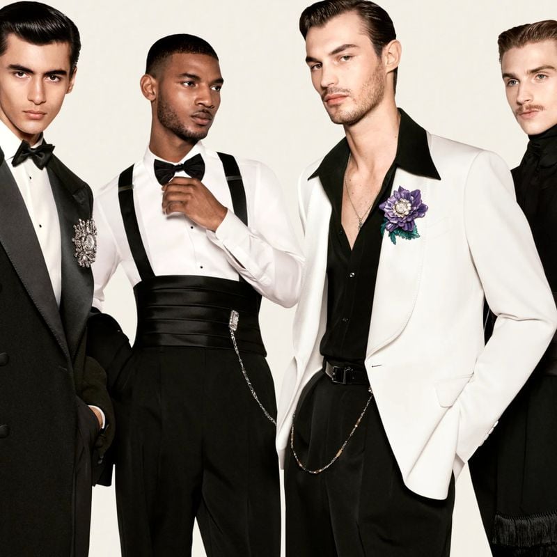 Akbar Shamji, Reece Nelson, Kit Butler, and Ruben Aiello stand in tuxedo jackets and bow ties with jeweled floral brooches