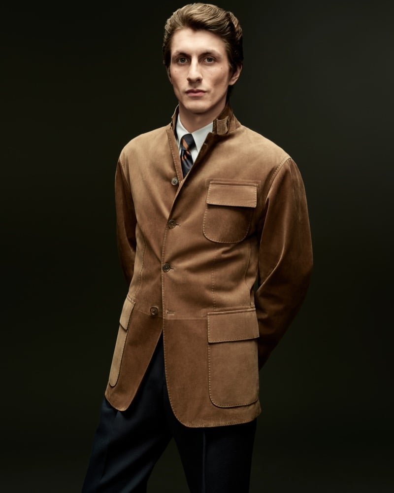 Henry Kitcher wears a camel suede jacket with black trousers for Dunhill's fall-winter 2026 campaign
