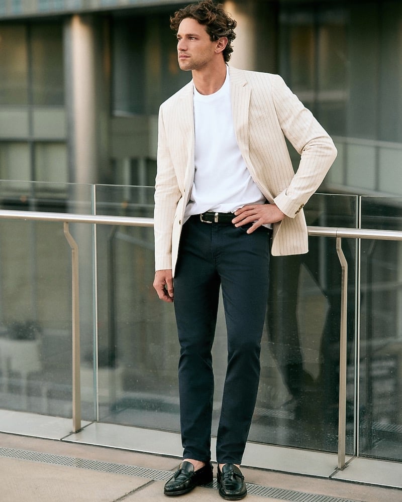 Giacomo Cavalli in a striped linen jacket, white T-shirt, and midnight blue traveler pant