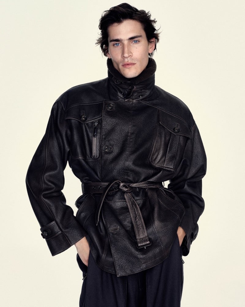 Liam Kelly wears a belted grained leather field jacket with a shearling collar and dark trousers for Giorgio Armani's fall-winter 2026 campaign