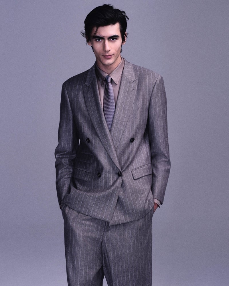 Akbar Shamji wears a gray double-breasted pinstripe suit with a striped tie for Giorgio Armani's fall-winter 2026 campaign