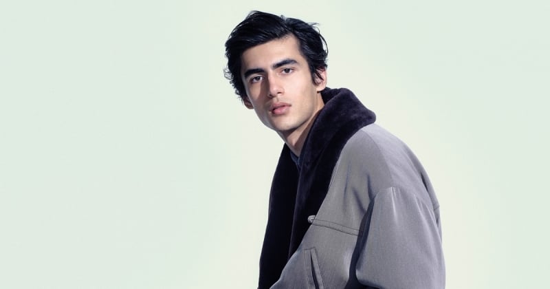 Akbar Shamji wears a gray jacket with a dark shearling collar for Giorgio Armani's fall-winter 2026 campaign