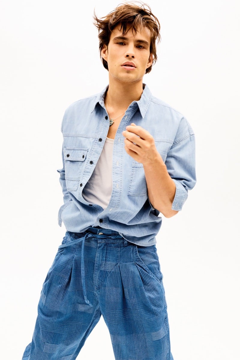 Louis Baines in a light blue chambray shirt and patchwork denim trousers, for Isabel Marant Fall 2026
