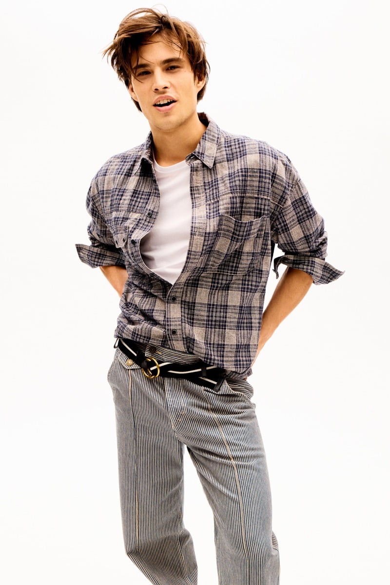Louis Baines in a plaid flannel shirt over a T-shirt with striped trousers, for Isabel Marant Fall 2026