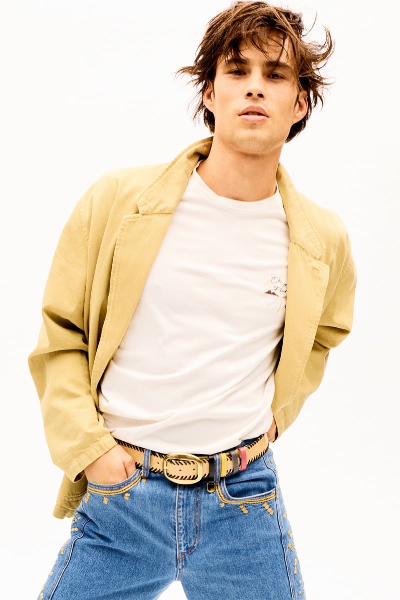 Louis Baines in a tan jacket over a graphic T-shirt and embroidered jeans, for Isabel Marant Fall 2026