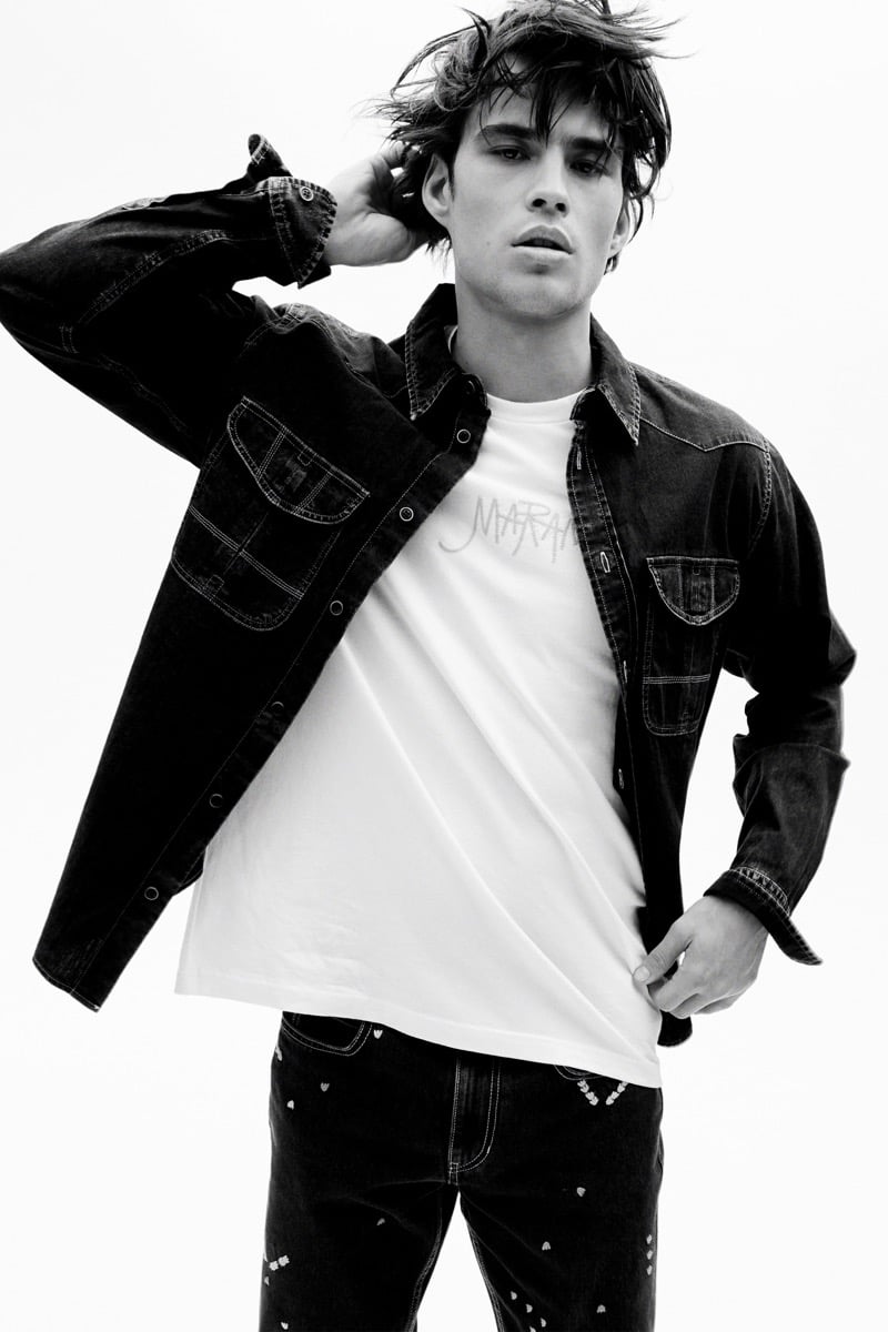 Louis Baines in a black-and-white image wears a denim jacket over a logo T-shirt, for Isabel Marant Fall 2026