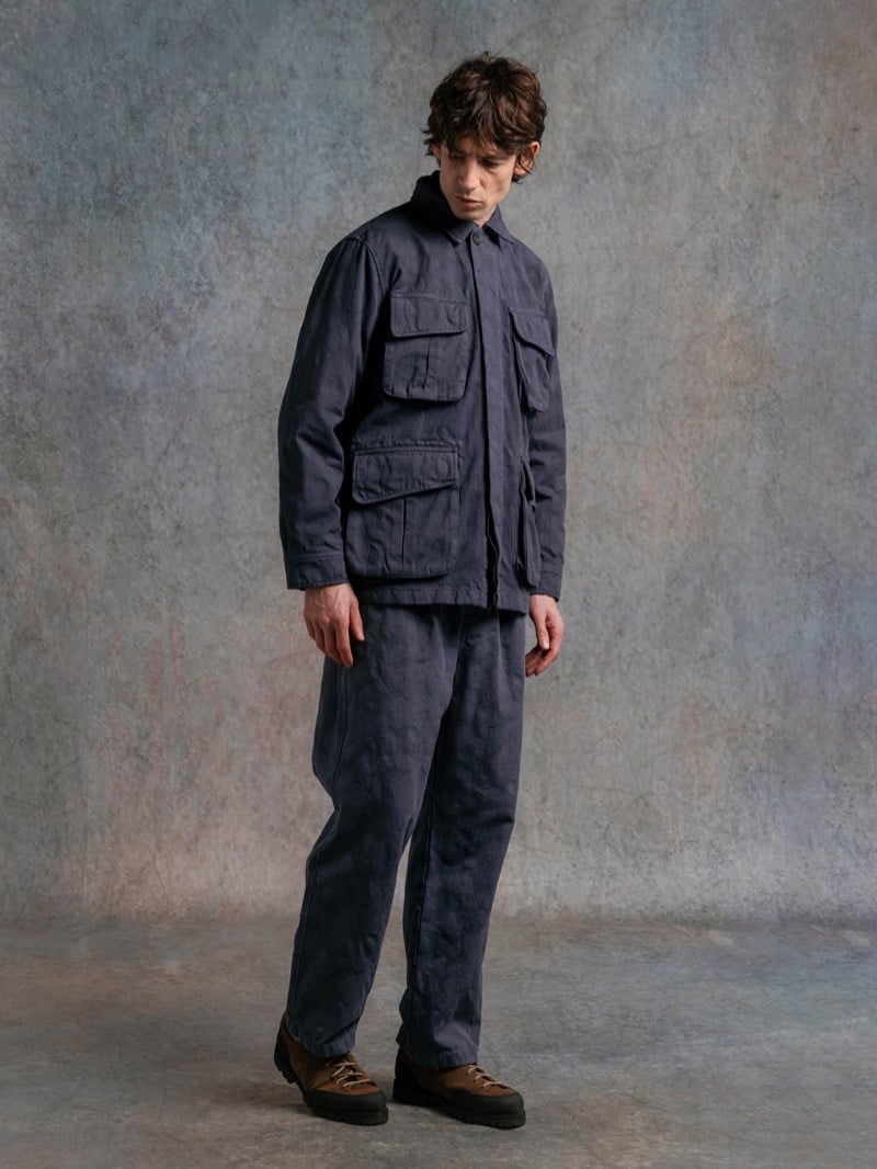 Man in a slate blue field jacket with cargo pockets, wearing a cap, for Kestin Fall 2026