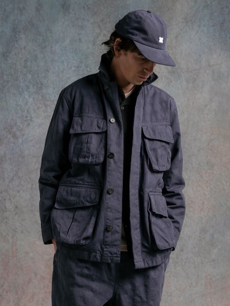 Man in a slate blue field jacket with cargo pockets, wearing a cap, for Kestin Fall 2026
