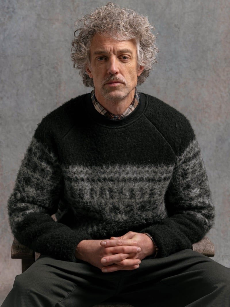 Man in a black and gray Fair Isle sweater over a plaid collared shirt, for Kestin Fall 2026