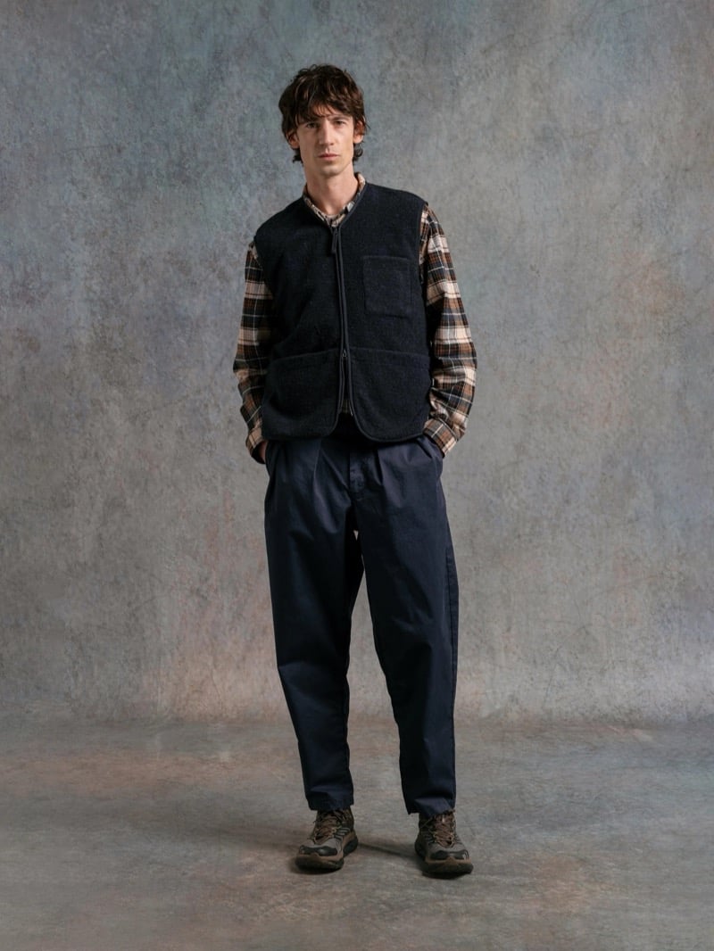Man in a black wool vest over a plaid shirt, for Kestin Fall 2026