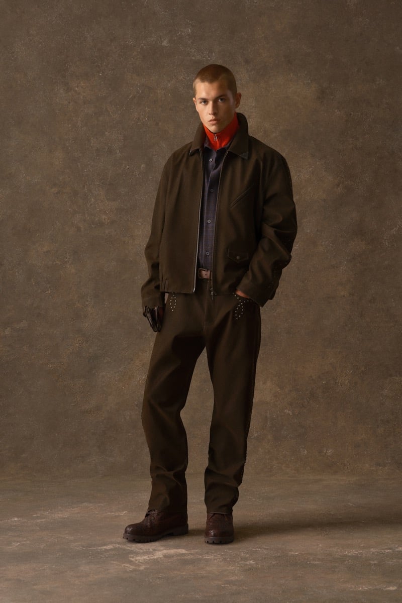 Man in a dark brown zip jacket over an orange mock neck, for Kith Fall 2026