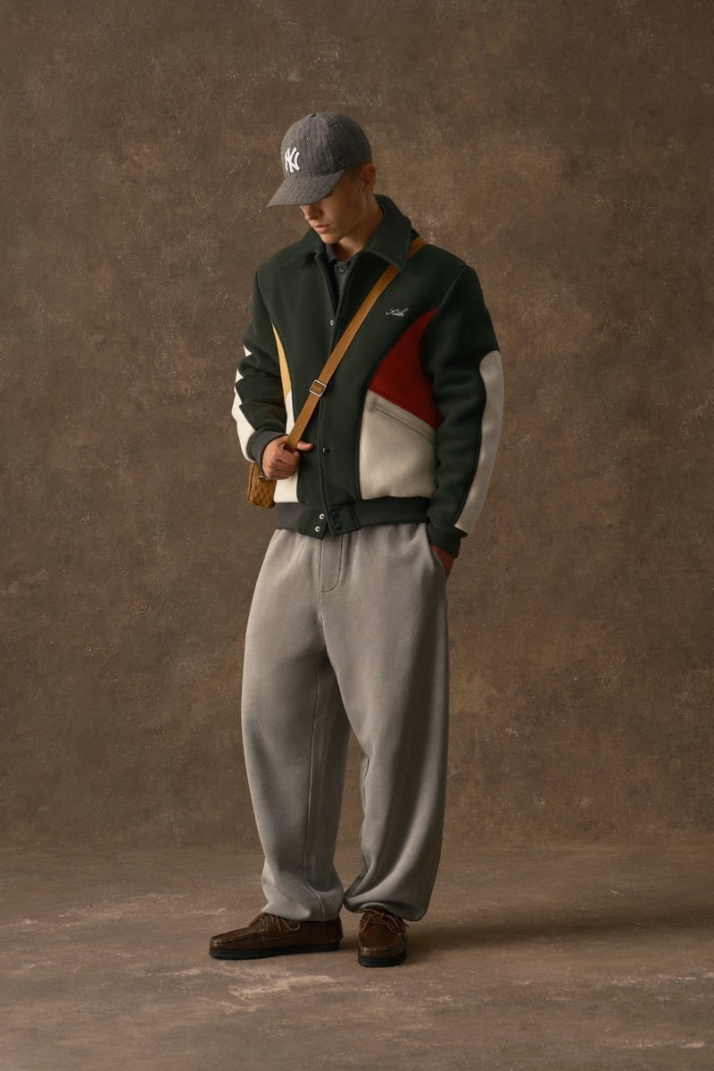 Man in a colorblock varsity jacket with a script logo, wearing gray sweatpants, for Kith Fall 2026