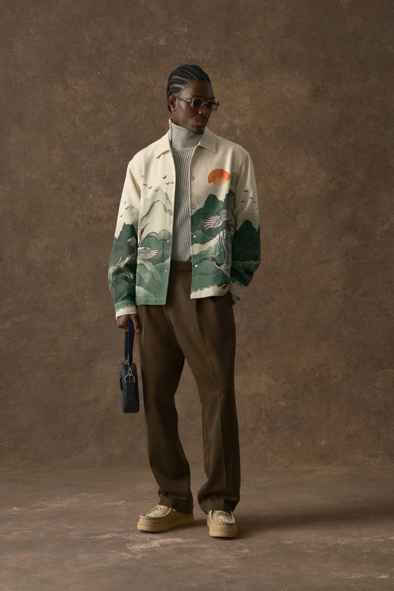 Man in a cream jacket printed with a crane and mountain landscape, wearing a turtleneck, for Kith Fall 2026