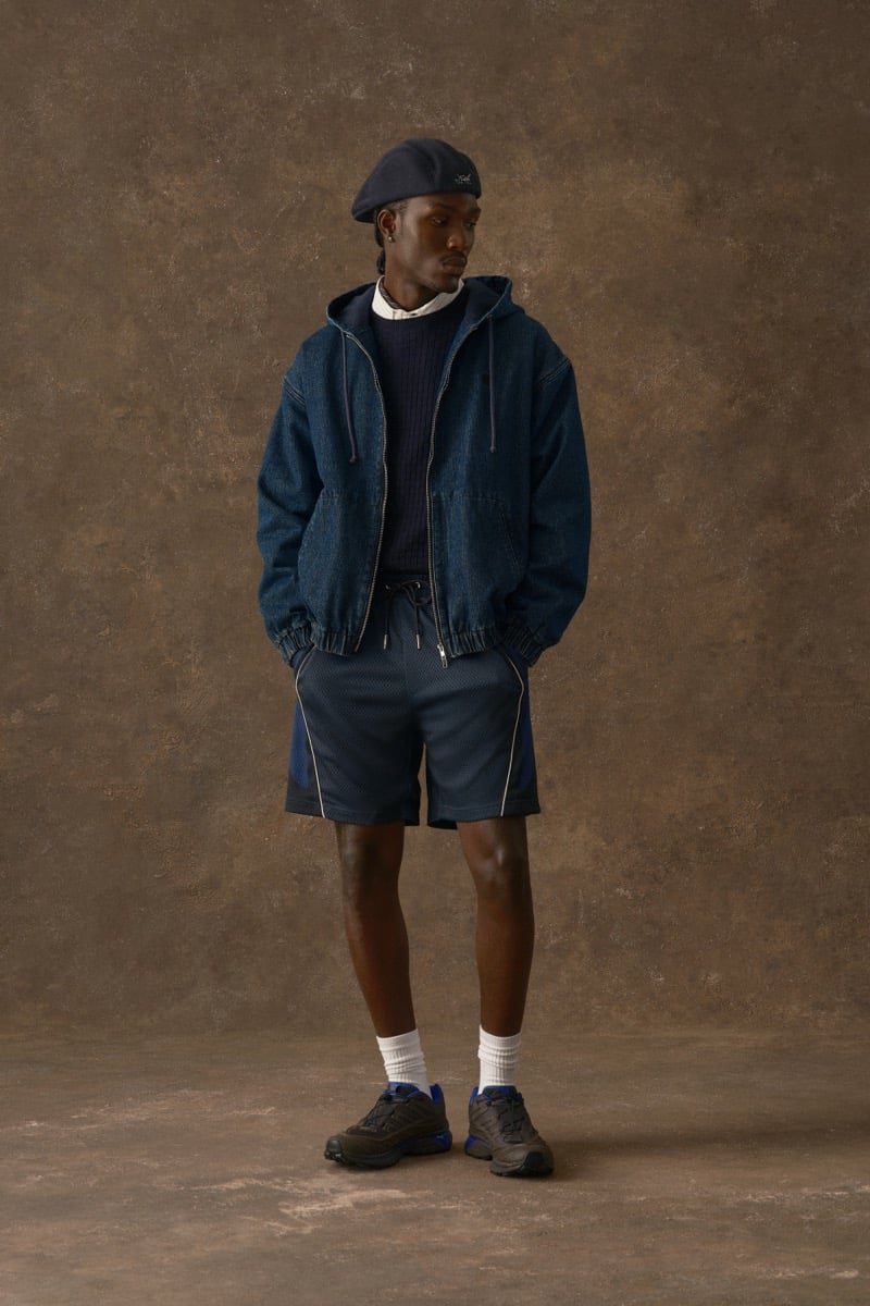 Man in an indigo denim hooded jacket, wearing mesh shorts and white socks, for Kith Fall 2026