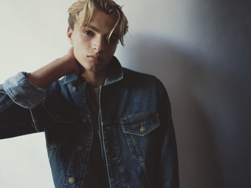 Maurits Scheij in a denim trucker jacket, close-up studio portrait