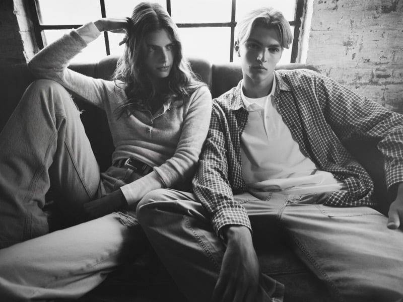 Black and white portrait of Maurits Scheij and Maya Gunn seated together on a couch