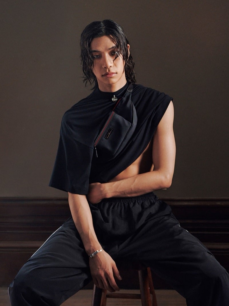 Tarzzan wears an asymmetric draped top with a cross-body bag accented in red for Gucci's Primavera campaign