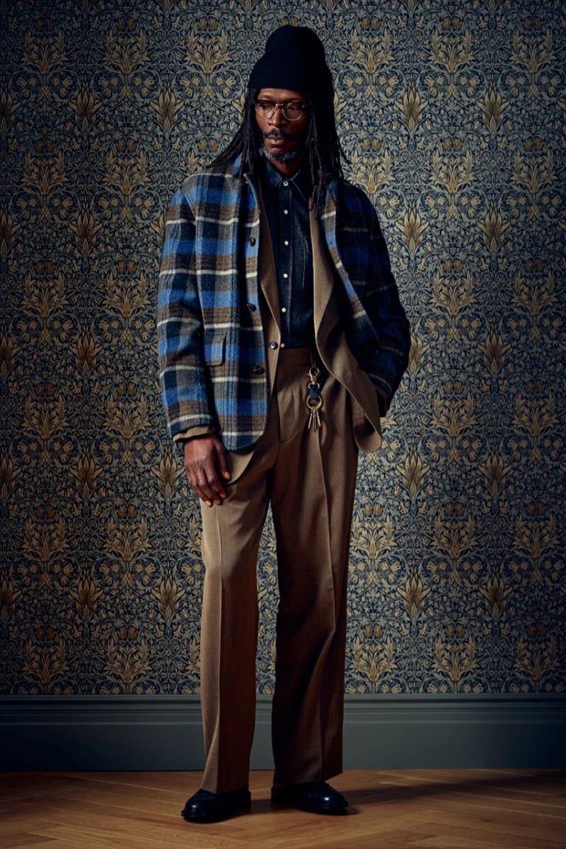 Man in a blue plaid wool jacket and tan trousers, wearing a beanie and glasses, for Todd Snyder Fall 2026