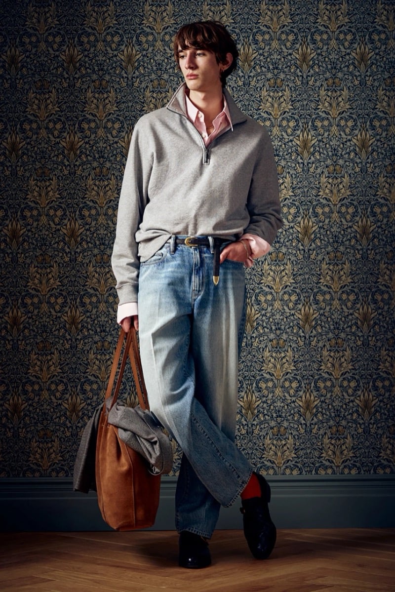 Man in a gray quarter-zip pullover and jeans, carrying a tan tote bag, for Todd Snyder Fall 2026