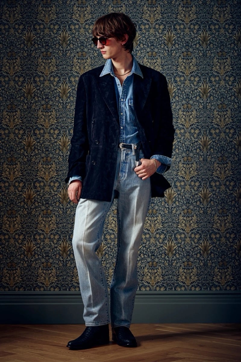 Man in a dark suede double-breasted jacket over a chambray shirt and light jeans, for Todd Snyder Fall 2026