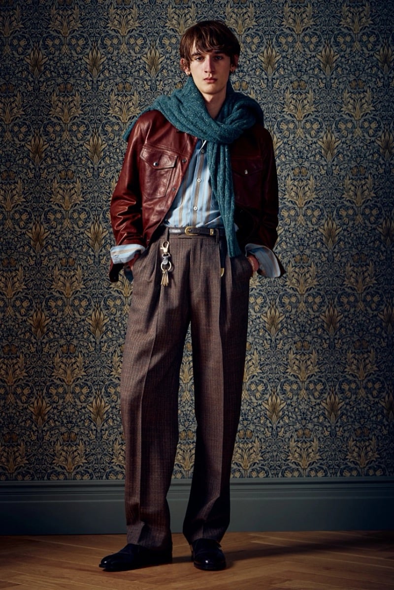 Man in a burgundy leather jacket with a teal scarf and striped shirt, for Todd Snyder Fall 2026