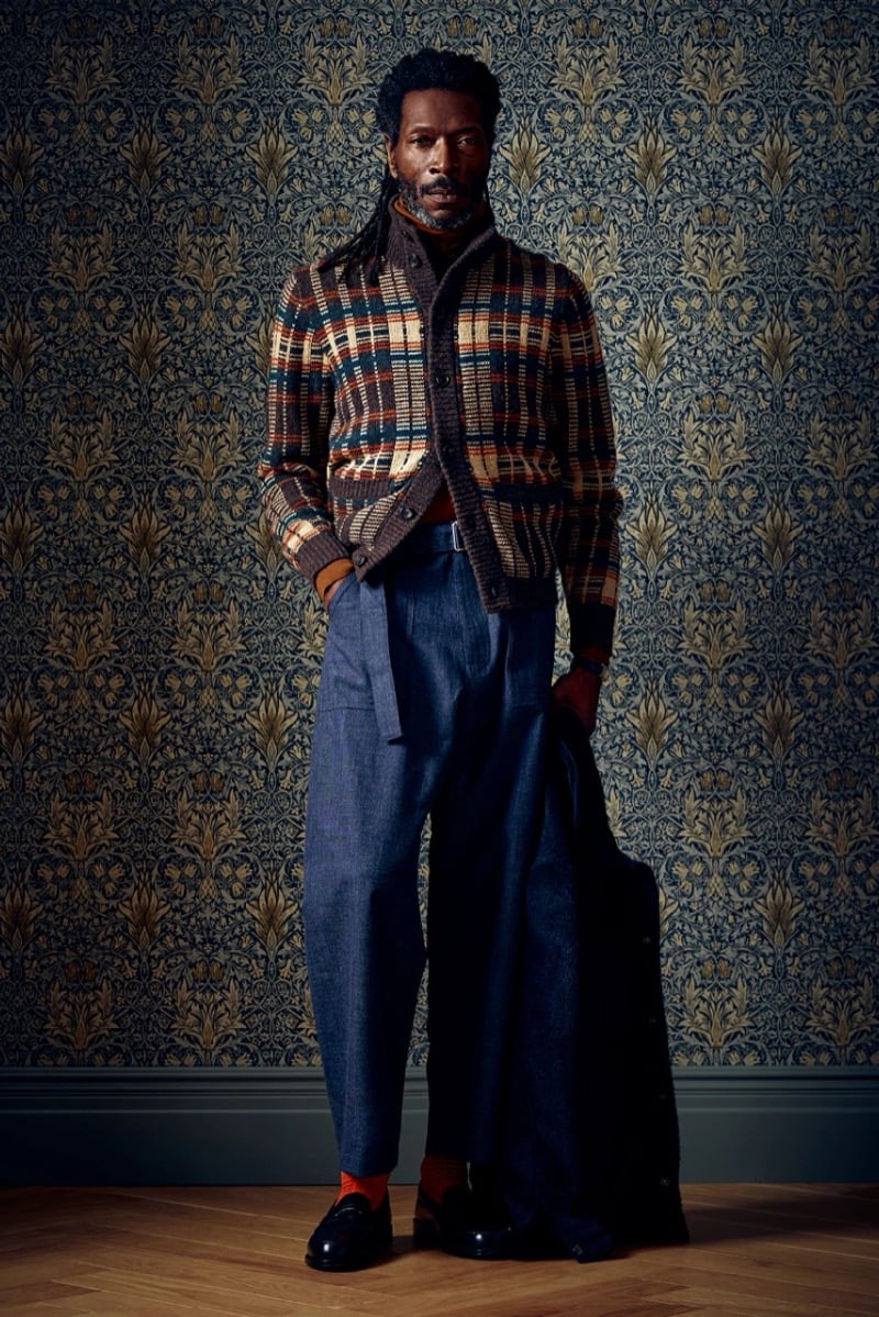 Man in a plaid cardigan over a dark turtleneck, holding a coat, for Todd Snyder Fall 2026