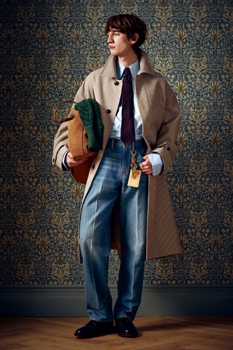 Man in a tan houndstooth coat with a burgundy tie, carrying a tan tote bag, for Todd Snyder Fall 2026