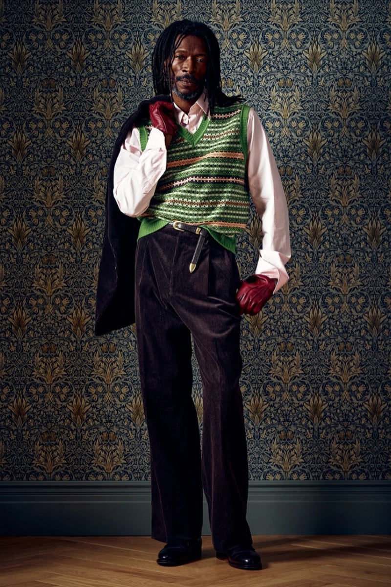 Man in a green fair isle sweater vest with a pink shirt and red gloves, for Todd Snyder Fall 2026