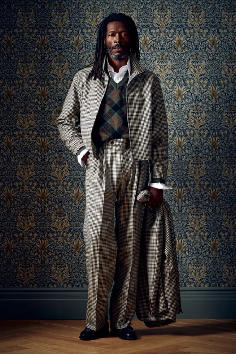 Man in a houndstooth coat and trousers over a green argyle sweater vest, for Todd Snyder Fall 2026