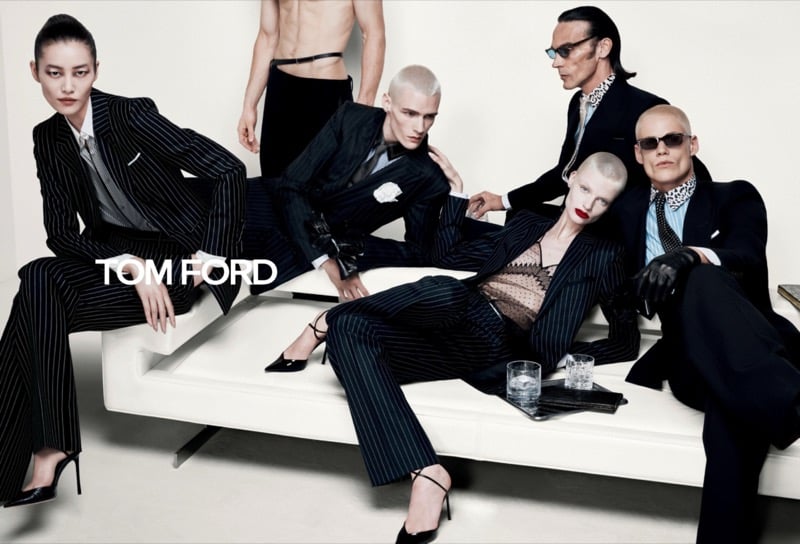Liu Wen, Paolo Grebic, Scott Barnhill, Mila Van Eeten, and Benjamin Orlando pose on a low platform in pinstripe suits, leather gloves, and sunglasses for Tom Ford's fall-winter 2026 campaign