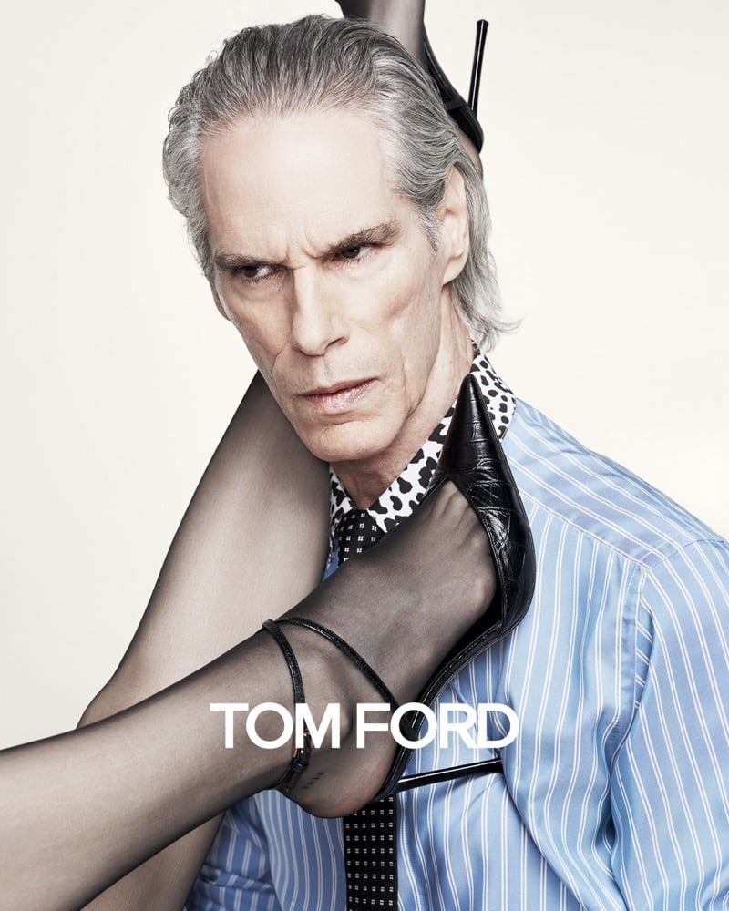 Alfredo Ramirez holds a stiletto heel at his shoulder while wearing a blue striped shirt, polka-dot tie, and spotted scarf for Tom Ford's fall-winter 2026 campaign