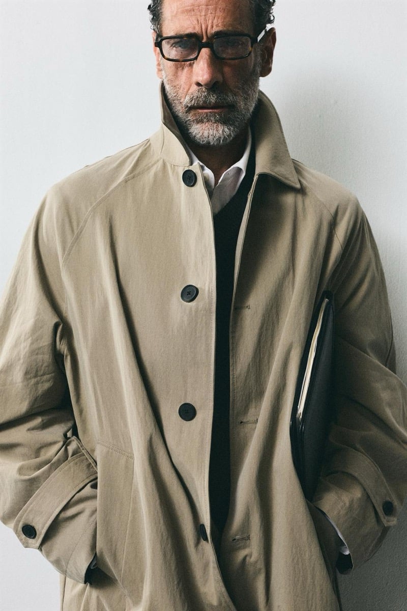 John Armstrong wears a tan trench coat and holds a black leather portfolio for Zara's back to work 2026 campaign