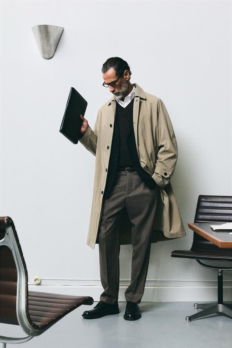 John Armstrong wears a tan trench coat and holds a black folder for Zara's back to work 2026 campaign