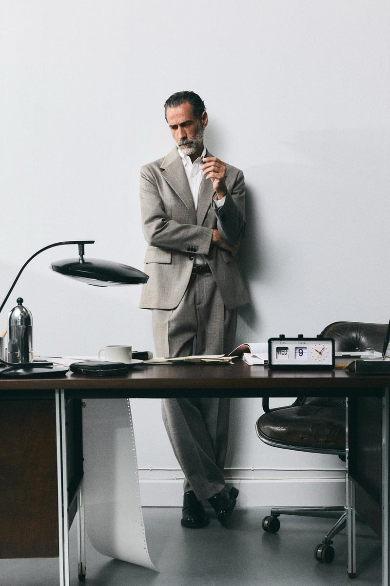 John Armstrong wears a gray suit while standing at a desk for Zara's back to work 2026 campaign