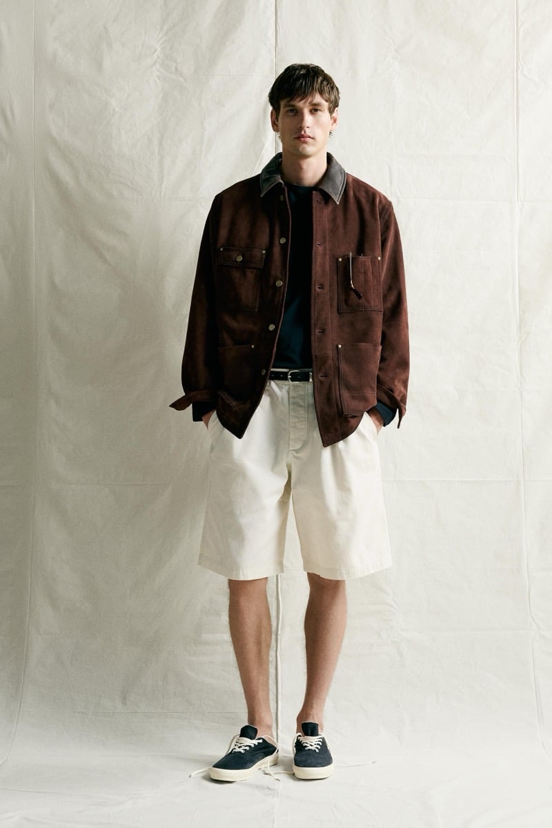 Jegor Venned in a brown multi-pocket jacket over a crew neck tee with shorts