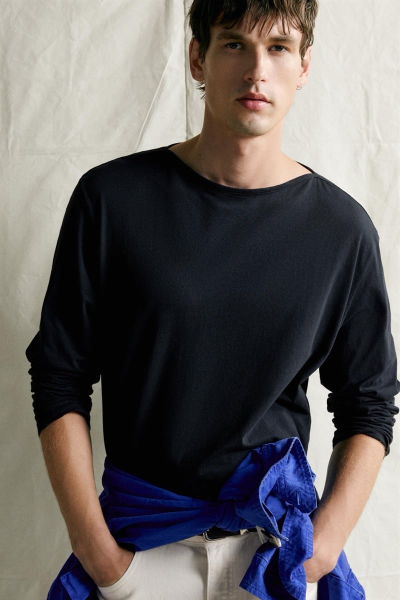 Close-up of Jegor Venned in a dark long-sleeve tee with a cobalt jacket tied at his waist