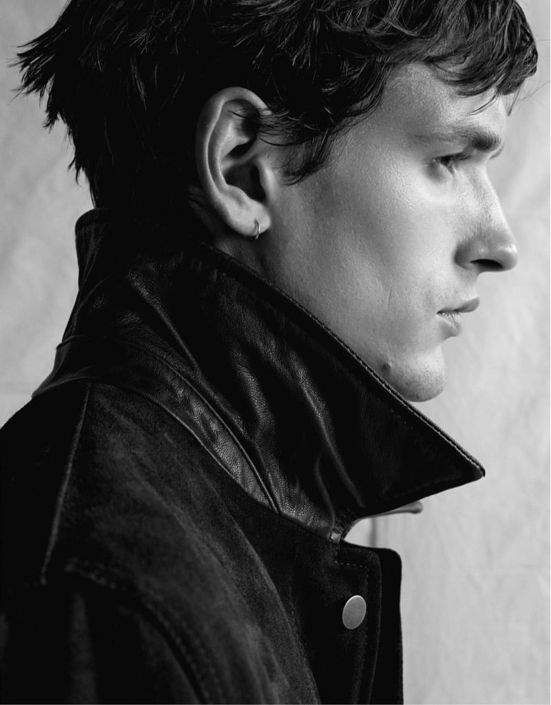 Black and white close-up profile of Jegor Venned in a leather jacket collar