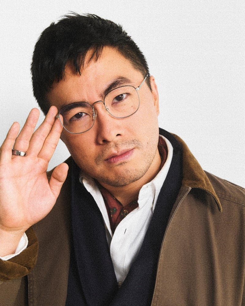 Bowen Yang in wire-frame glasses, a J.Crew Barn Jacket with a corduroy collar, scarf, and collared shirt