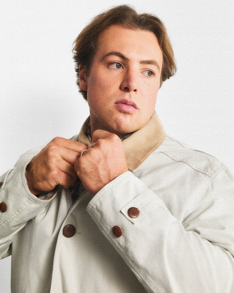 Charlie McAvoy buttons a light canvas J.Crew Barn Jacket with a corduroy collar