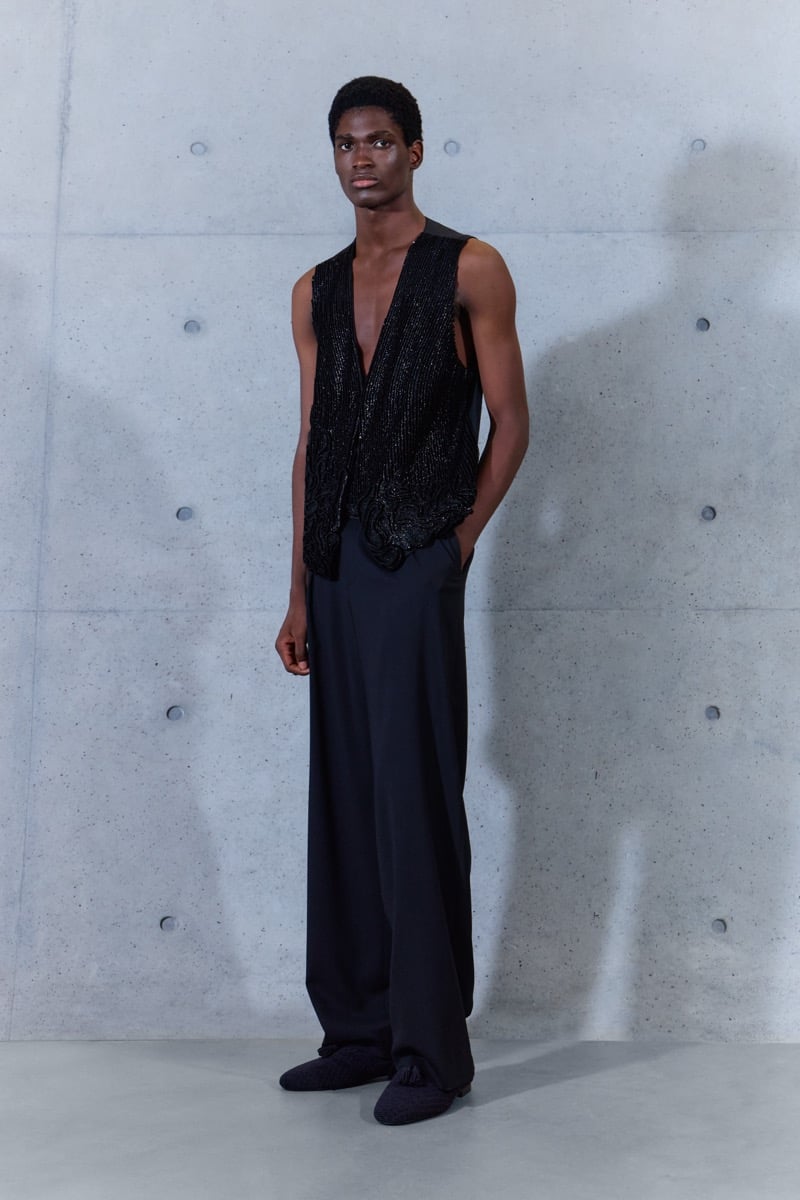 A model in a beaded waistcoat with wide-leg trousers, for Emporio Armani's spring-summer 2027 collection