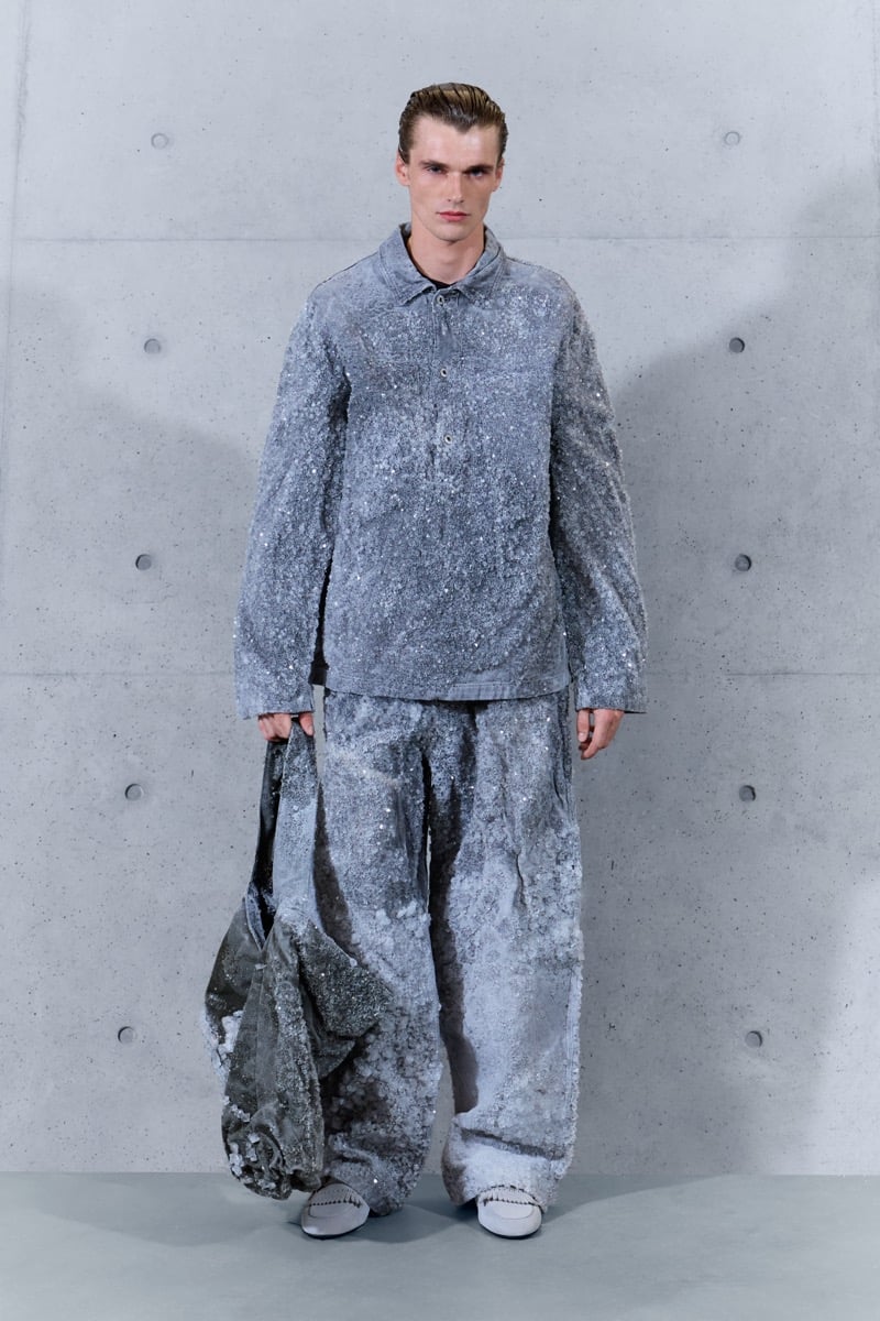 A model in a crystal-encrusted shirt and matching wide-leg trousers, with a matching bag, for Emporio Armani's spring-summer 2027 collection