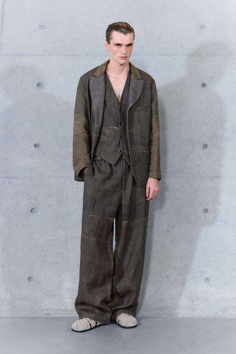 A model in a faded jacket and waistcoat with matching wide-leg trousers, for Emporio Armani's spring-summer 2027 collection