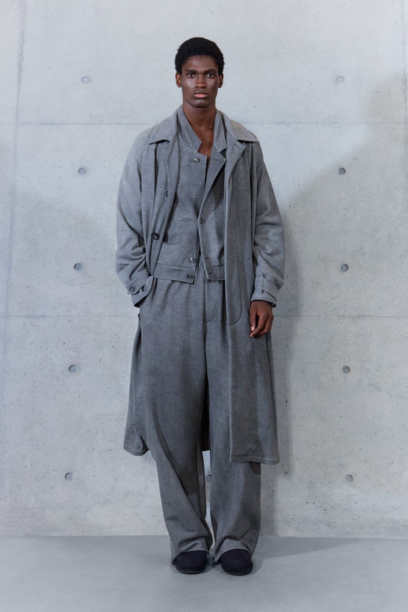 A model in a long gray coat over a cropped jacket, with matching wide-leg trousers, for Emporio Armani's spring-summer 2027 collection