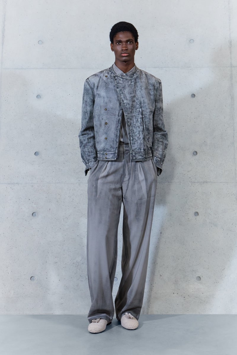 A model in a mottled cropped jacket with pleated wide-leg trousers, for Emporio Armani's spring-summer 2027 collection